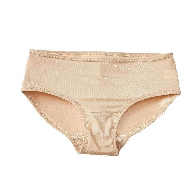 Hudfärgade dambyxor mot vit bakgrund. Push up-trosa med vadderad bakdel